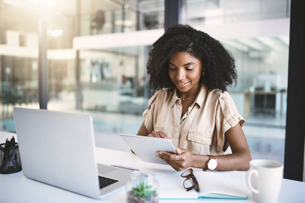 Expert en affaires au travail. une jeune femme d'affaires utilisant une tablette numérique à son bureau dans un bureau moderne - Photo, image