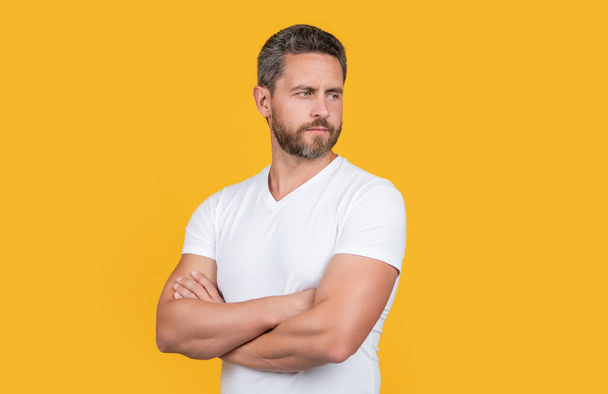 handsome guy wearing casual style. bearded guy in casual shirt isolated on yellow background. casual guy in studio. photo of caucasian guy wear white shirt. - 写真・画像