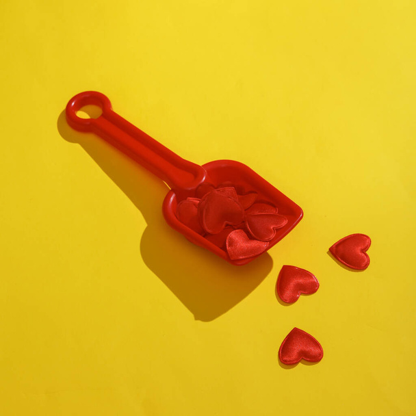 sandbox paddle with hearts on a yellow background. Valentine's day, love concept - Fotografie, Obrázek
