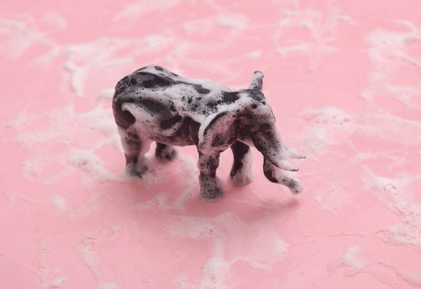 Toy elephant in foam on a pink background - Photo, Image