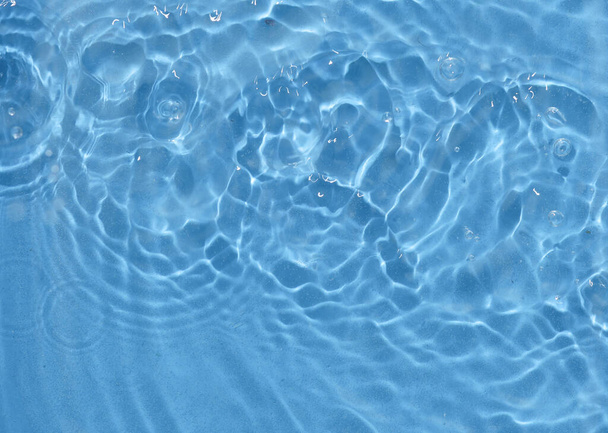 Pink water surface with rings and ripples. Spa concept background. - Photo, Image