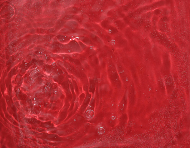 Red water surface with rings and ripples. Spa concept background. - Photo, Image