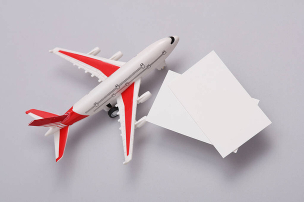 White Blank business cards for branding and toy air plane on gray background. Creative Mockup for presentations and corporate identity. Travel Company. - Foto, Bild