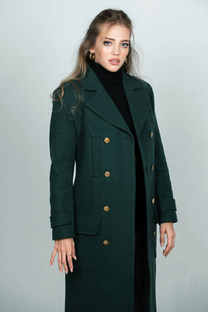 Vogue female coat. Young glamour woman wearing stylish fashion dress. Fashion model in studio - Foto, Imagem