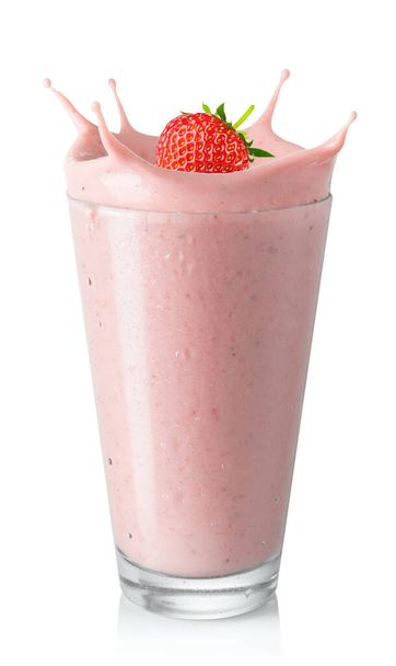 glass of strawberry smoothie or milkshake with splash and falling berry isolated on white background - Foto, imagen