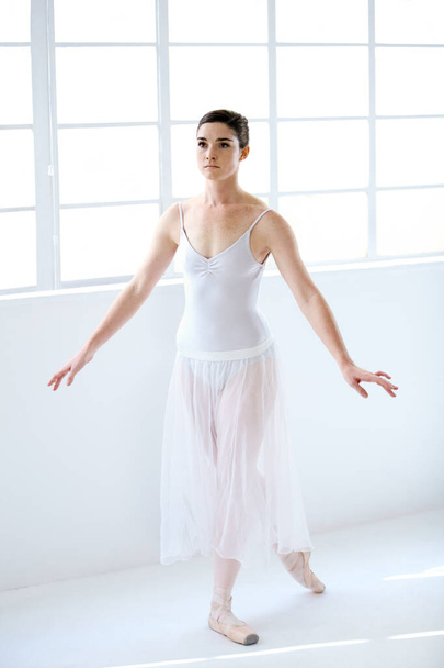 Dance, ballet and focus with woman in studio for balance, elegant and performance. Artist, theatre and training with female ballerina dancing in class for competition, freedom and commitment. - Foto, immagini
