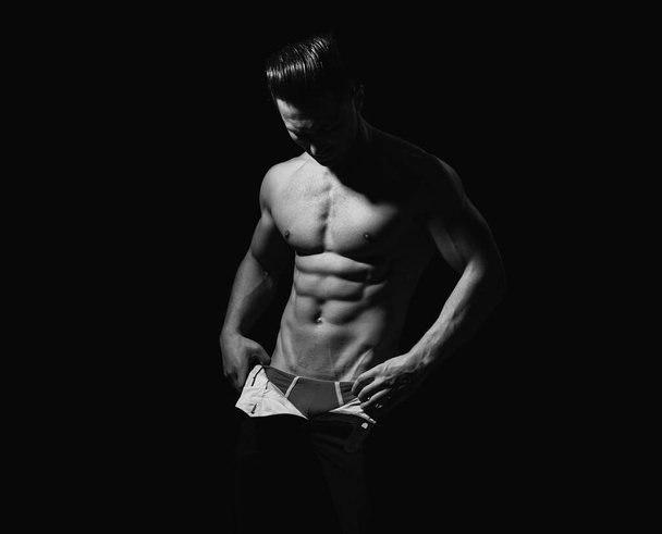 Muscular shirtless man model. Muscled male torso with abs - Zdjęcie, obraz