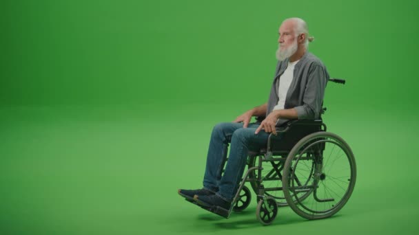 Pantalla verde.Un anciano triste en silla de ruedas sintiéndose solo Comunidad y apoyo social para personas mayores en sillas de ruedas. Salud mental de las personas mayores. - Metraje, vídeo