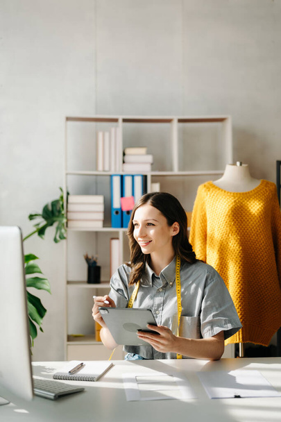 Young business owner woman  checking online orders for deliver to customer with tablet and laptop. Shopping Online concept. in office - Foto, Imagem