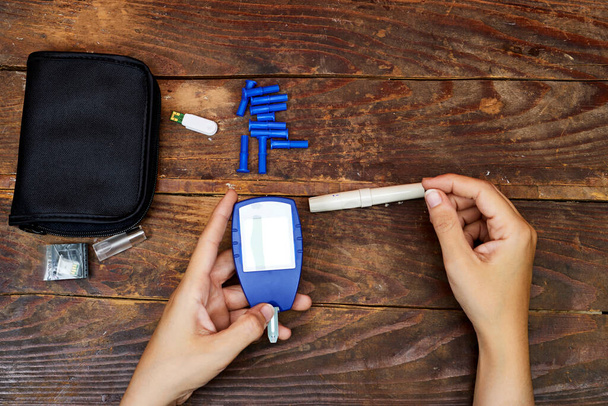 check blood sugar level with glucometer. Treatment of diabetes concept - Photo, image