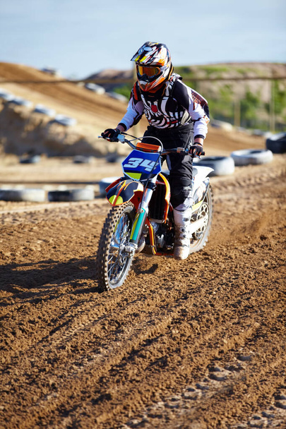 Adventure, offroad and biker riding a motorcycle with speed for a race or sport competition. Sports, fitness and male athlete on motorbike for adrenaline, training or practicing on outdoor dirt trail. - Photo, Image