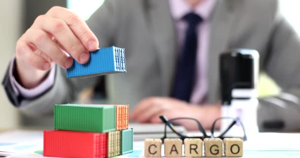 Cargo inscription on wooden cubes in office of dealer counts profit of delivery. Logistic services concept - Materiaali, video
