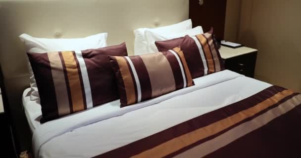 Modern stylish beautiful hotel room with large bed in the evening interior concept - Video