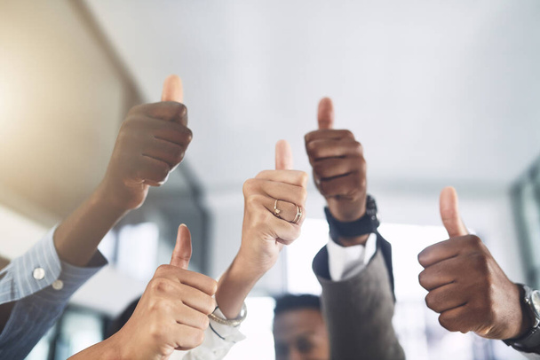 Your talents are amazing. Closeup shot of a group of businesspeople showing thumbs up in an office - Photo, Image