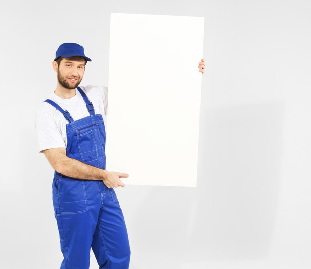 Handsome builder with white board - Foto, Imagen