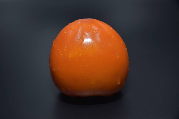 a closeup shot of a single fresh ripe apricot isolated on black background  - Photo, image