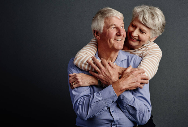 Youre the only one I need. Studio shot of an affectionate senior couple posing against a grey background - Φωτογραφία, εικόνα