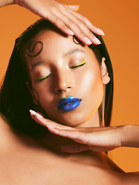 Neon makeup, cosmetics and face of woman in studio for art deco, eye shadow and beauty salon. Creative aesthetic, cosmetology and female person with blue lipstick for glamour, luxury style and glow. - 写真・画像