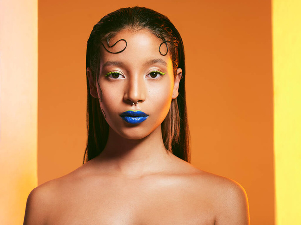 Makeup, blue lipstick and portrait of woman in studio for cosmetics, eye shadow and beauty with color. Creative, cosmetics and face of female person on yellow background for glamour, fashion or style. - Fotografie, Obrázek