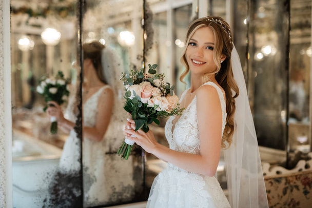portrait of a bride in a white dress in a bright cafe with mirrors - Valokuva, kuva
