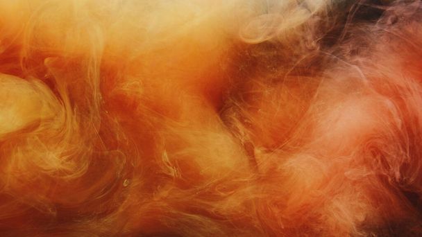 Color vapor splash. Ink water. Fire flame explosion. Yellow orange red fume cloud texture on black abstract art background. - Φωτογραφία, εικόνα