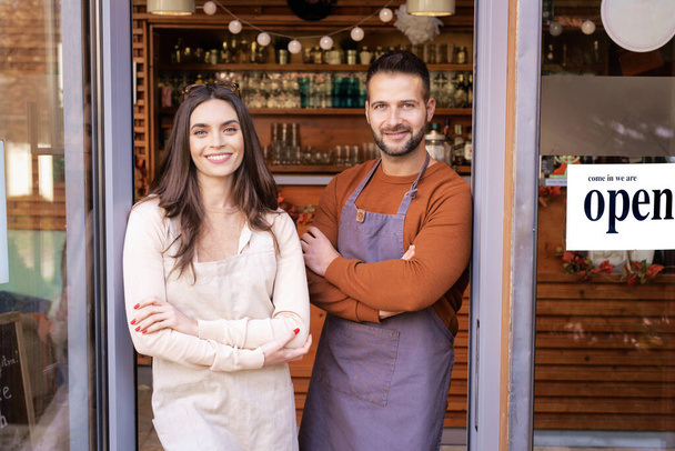 Small business owner woman and man standing at the cafe door - Foto, Bild