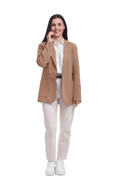 Beautiful businesswoman talking on smartphone against white background - Foto, immagini