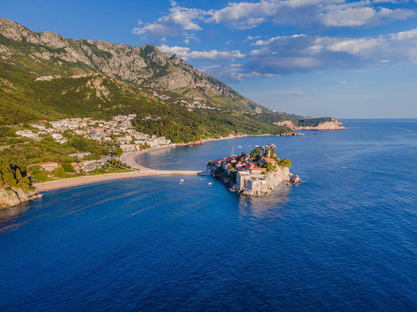 Aerophotography. Aerial view of Sveti Stefan island in a beautiful summer day, Montenegro from flying drone. Panoramic above view of Saint Stephen luxury resort. Tourism and leisure concept. - Foto, Imagem