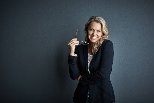 I find fulfillment in being a leader. Studio portrait of a mature businesswoman posing against a grey background - Foto, Bild