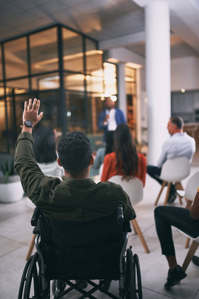 Inclusivity breaks all boundaries. an unrecognizable businessperson raising their hand to ask a question during a conference at work - Photo, image