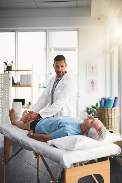 Youll be up on your feet again in no time. a young male physiotherapist assisting a senior patient in recovery - Valokuva, kuva