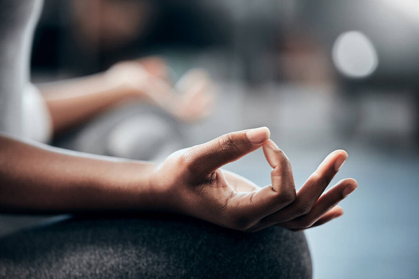 Yoga in gym, hands or woman in meditation in lotus pose with zen peace or mindfulness in blurry studio. Closeup, chakra or relaxed girl in pilates exercise workout for spiritual wellness or self care. - Photo, image