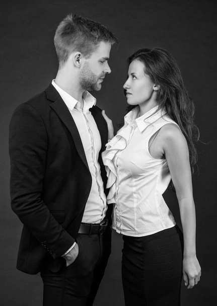 partnership of businesspeople. boss and employee. ambitious colleague experts. togetherness. business partners on black background. formal couple in love. businessman and businesswoman. - Фото, зображення