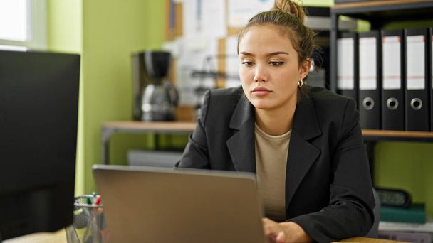 Young beautiful hispanic woman business worker using laptop working at office - 写真・画像