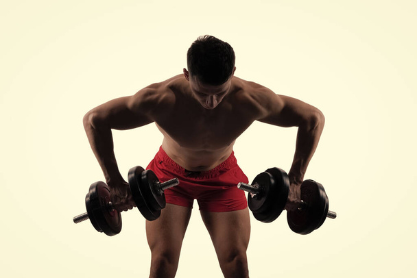 muscular man with gym dumbbell do weightlifting sport for biceps and triceps. weightlifting sport in gym. man do weightlifting in sport gym isolated on white. gym training of weightlifting sport. - 写真・画像