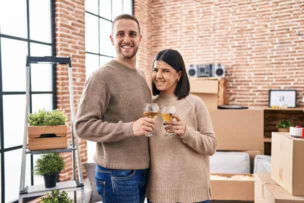 Чоловік і жінка пара посміхаються впевнено тости з шампанським в новому будинку
 - Фото, зображення