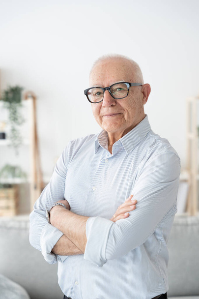 Portrait of confident elderly man with crossed arms - Photo, Image