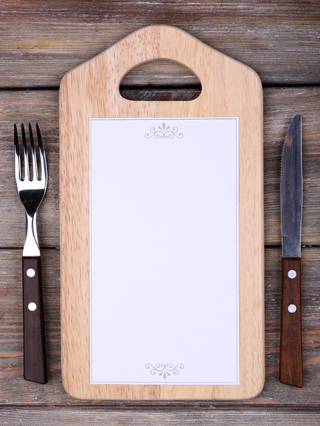 Cutting board with menu sheet of paper - Фото, изображение