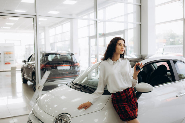 Car dealer woman. Auto dealership and rental concept background. - Photo, Image