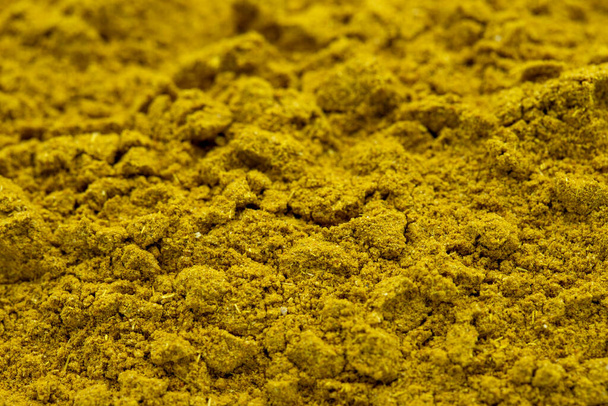 Pile of curry powder as background, spice or seasoning as background. Close-up curry powder - Fotó, kép