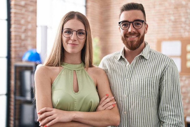 Man and woman business workers smiling confident standing with arms crossed gesture at office - Photo, image