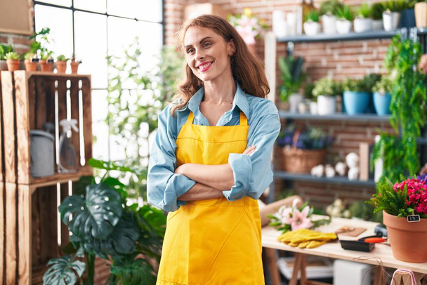 Young beautiful hispanic woman florist smiling confident standing with arms crossed gesture at florist - Фото, зображення