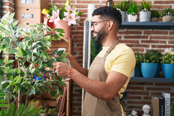 Young arab man florist using difusser working at florist - Foto, afbeelding