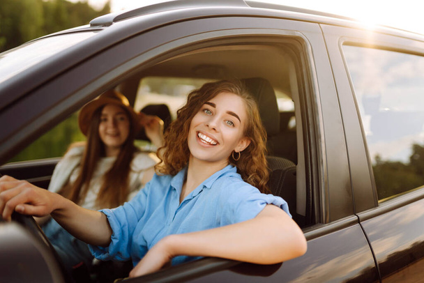 Two young women on car trip having fun. Lifestyle, travel, tourism, nature, active life. - Foto, imagen