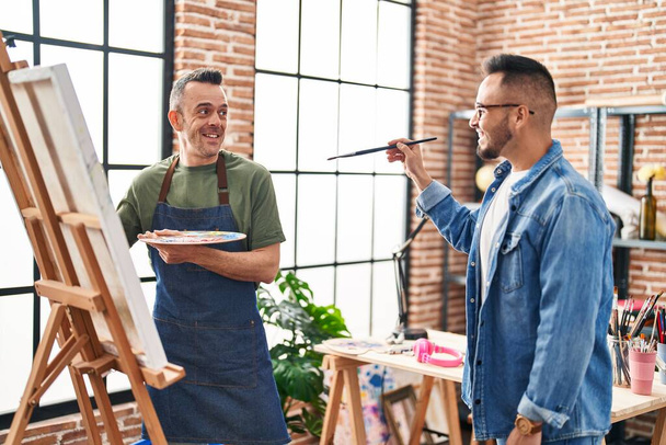 Two men artists smiling confident drawing at art studio - Foto, Bild