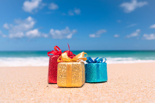 Gift boxes on sand with summer beach background. - Φωτογραφία, εικόνα