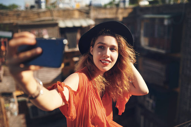 Loving yourself is the best thing you can do. a beautiful young woman taking selfies while out in the city - Photo, Image