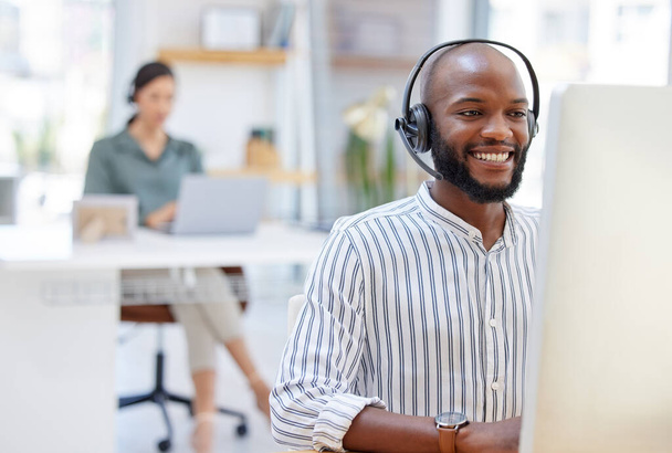 Call center, computer and happy man, virtual consultant or advisor in customer support, online advice and office. contact, communication and business agent or african person on desktop in workspace. - Фото, изображение