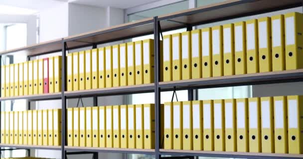 Red folder moves quickly among yellow ones. Archiving of business documents - Footage, Video