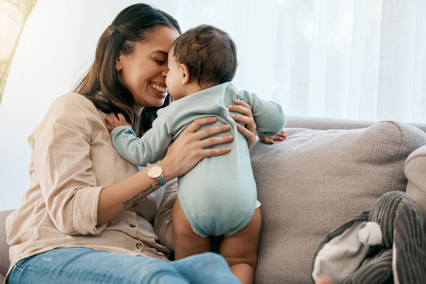 Love, happy and mother with baby on a sofa for playing, games and laughing in their home together. Family, smile and mom with girl toddler on a couch, relax and bonding, fun and hug in a living room. - Fotoğraf, Görsel